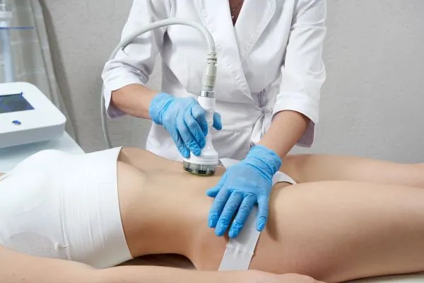 Lost the Weight but Not the Loose Skin? 2 woman having HIFU treatment on her stomach to combat loose skin Bournemouth following weight loss